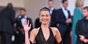 bella hadid wearing a vintage versace black dress at the 77th annual cannes film festival beating hearts premiere