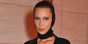 bella hadid attends exhibition opening at the museum of islamic art wearing black dress and head covering