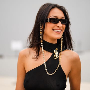 paris, france june 25 bella hadid wears sunglasses with a bejeweled diamonds chain, a black off shoulder cropped top with turtleneck, outside dior, during paris fashion week menswear springsummer 2022, on june 25, 2021 in paris, france photo by edward berthelotgetty images