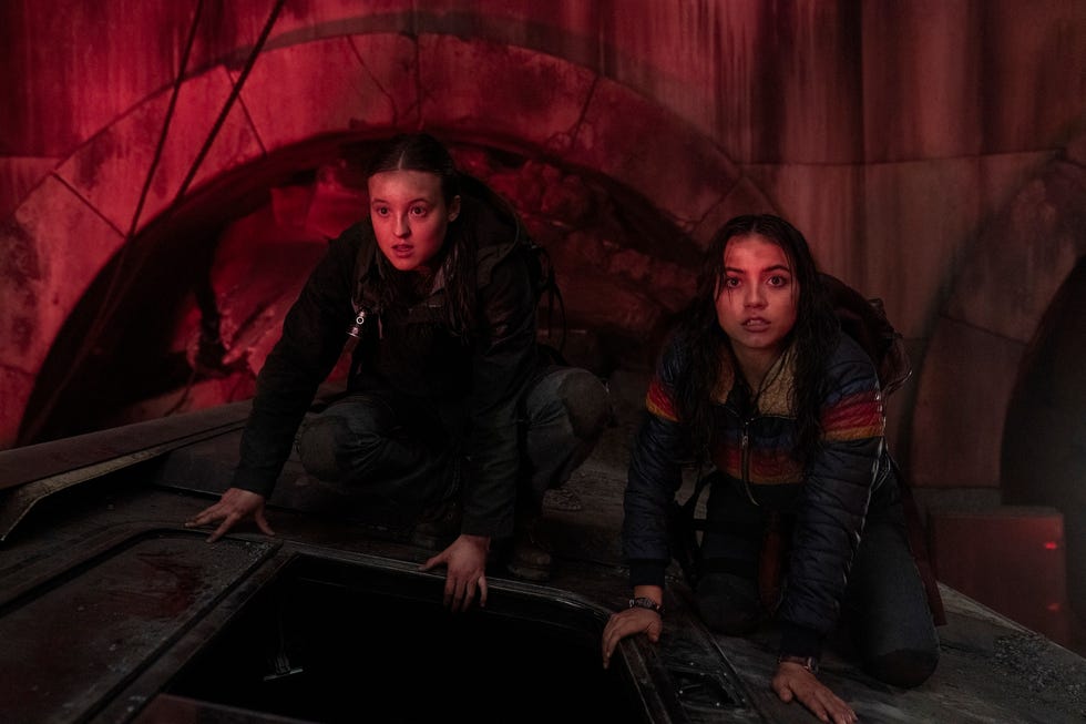 bella ramsey and isabela merced in a dimly lit underground area in a scene from the last of us season 2 episode 4