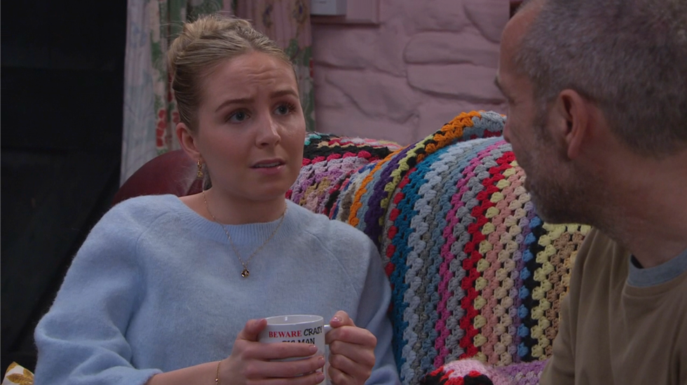 belle dingle talks to sam as she's holding a cup of tea on emmerdale