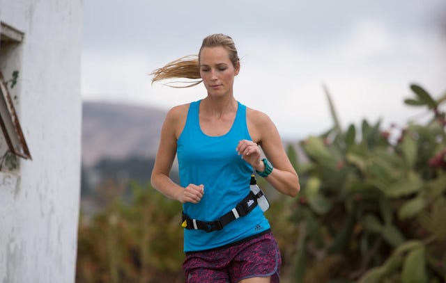 Woman running with water on belt