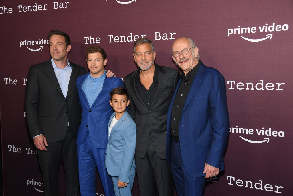 ben affleck, tye sheridan, daniel ranieri, george clooney and christopher lloyd stand in a line and pose for photos in front of a maroon photo backdrop