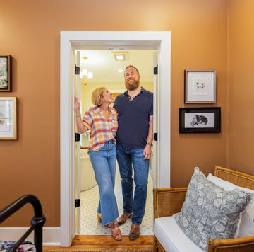 individuals standing in a doorway of a welldecorated room with artwork on the walls individuals standing in a doorway of a welldecorated room with artwork on the walls