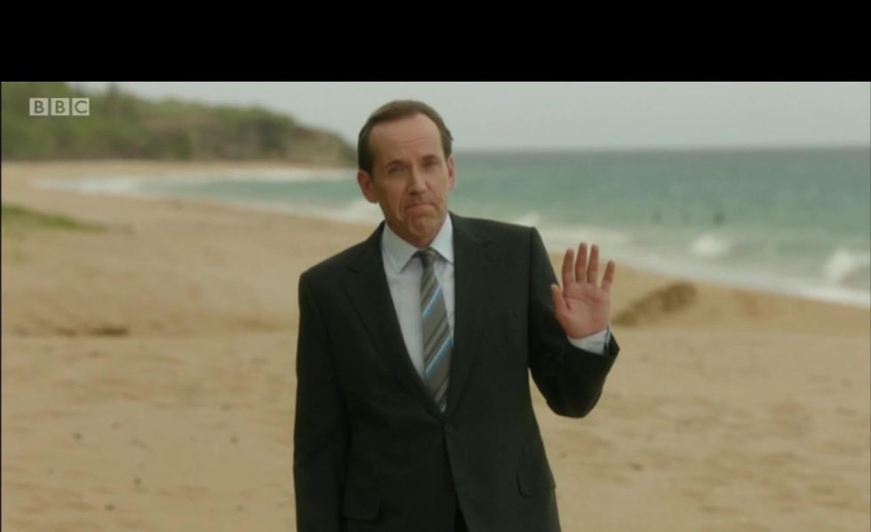 ben miller wears a suit on the beach in death paradise series 10