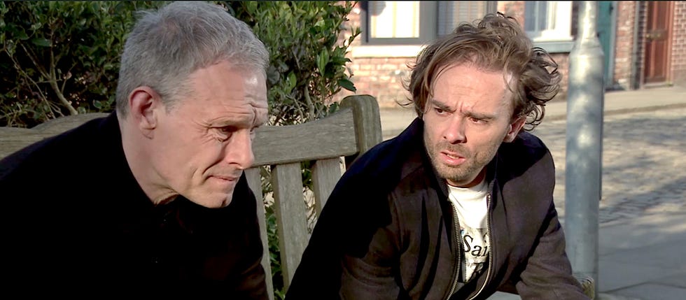 two men sitting outside