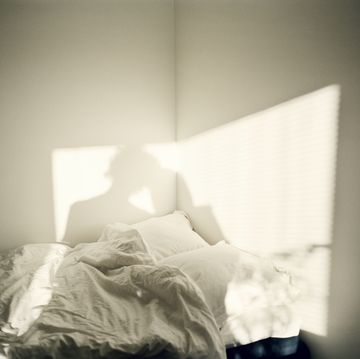 a person stands in front of a bed