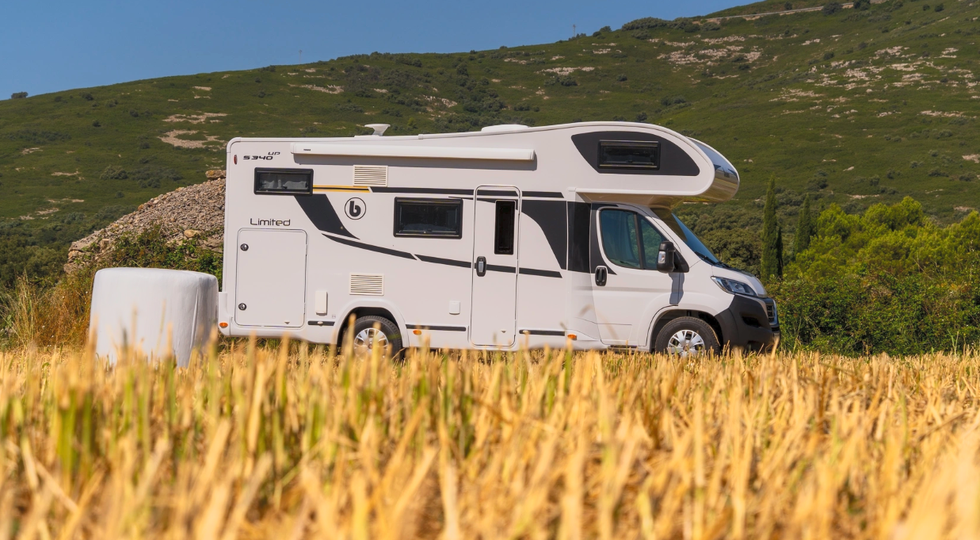 a white rv parked in a field