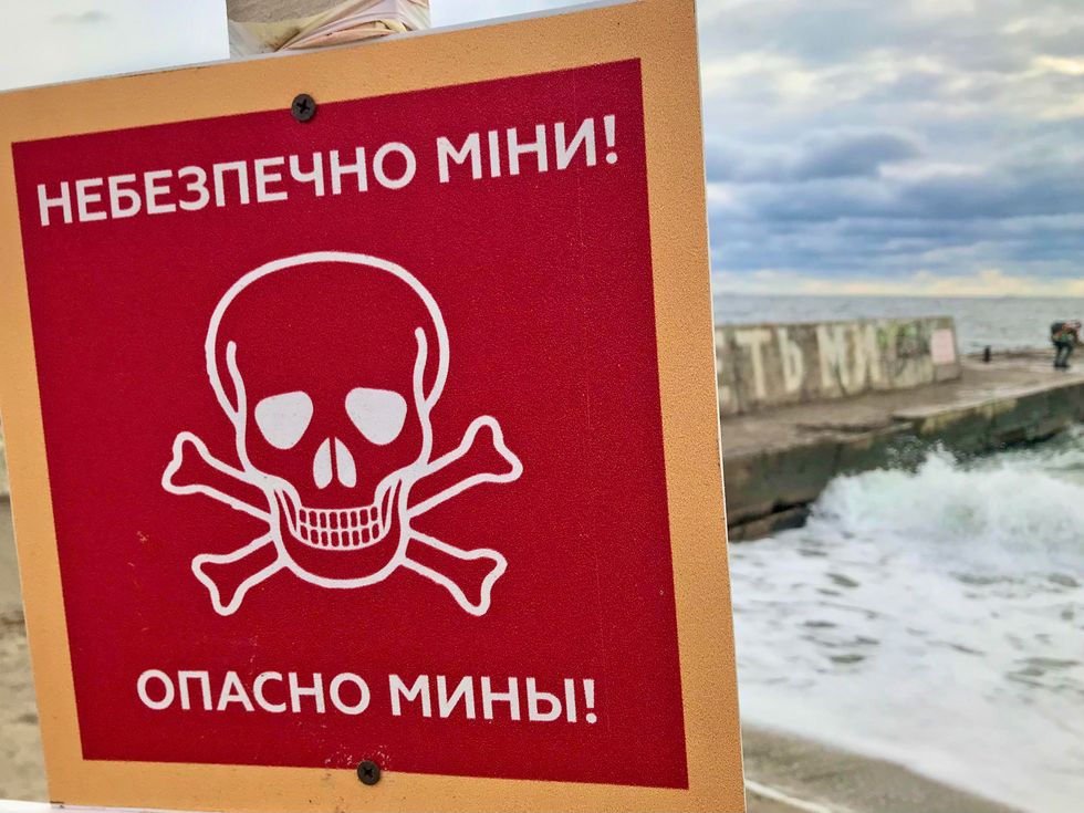 local and international volunteers support the resistance against the russian military in ukraine a warning sign at a mined beach in odesa