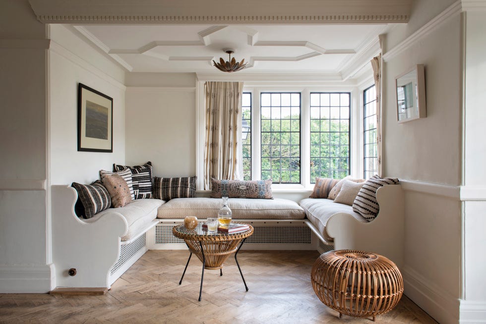 a window seat in a country home painted in neutral warm white shades