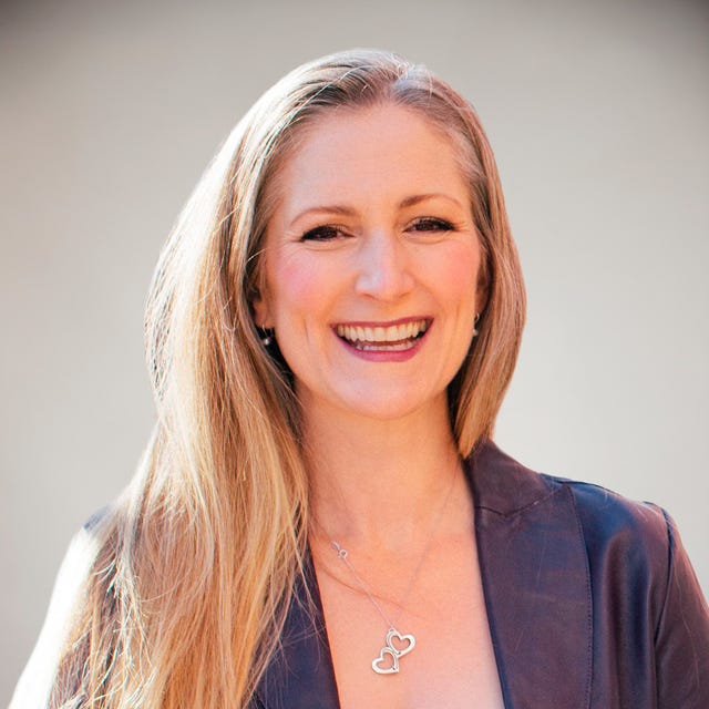 a woman with long hair smiling