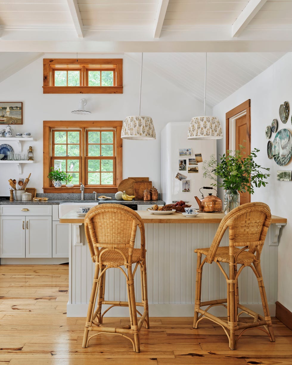 pale green and white beach house kitchen with raffia stools