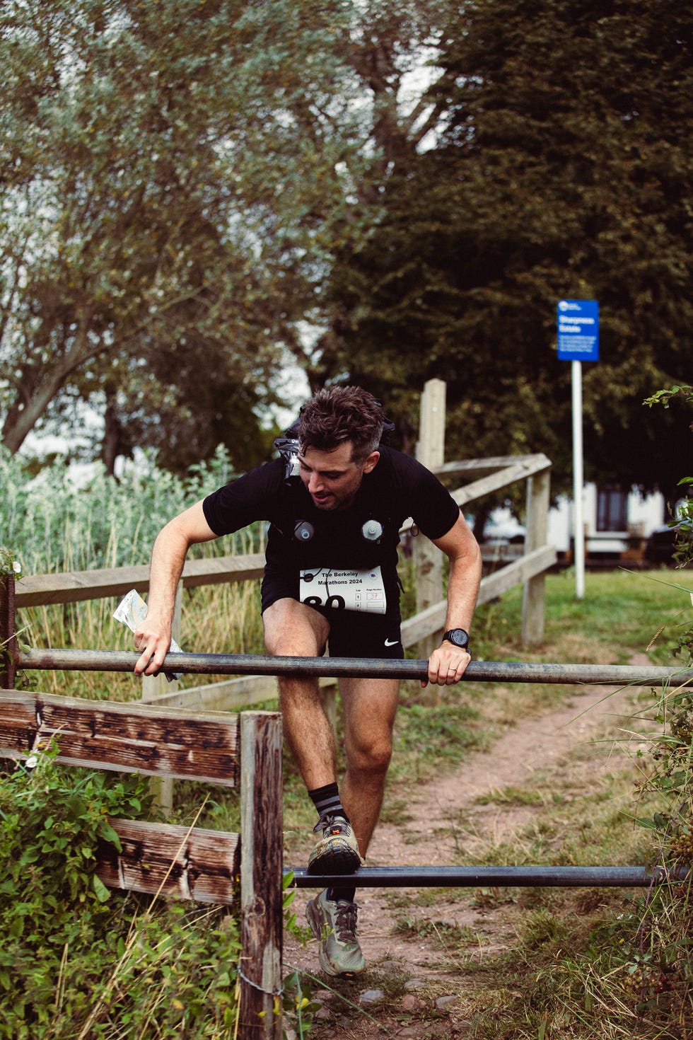 a man climbs over a gate