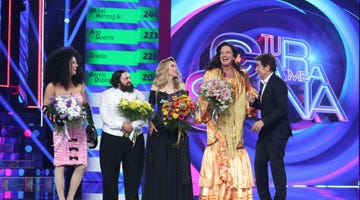 contestants holding bouquets on a television stage