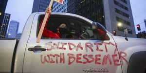 the words "solidarity with bessemer" are painted on a car as demonstrators participate in a tax amazon car caravan and bike brigade to defend a payroll based tax on big businesses, including amazon, that the city council passed last july in seattle, washington on february 20, 2021 photo by jason redmond  afp photo by jason redmondafp via getty images