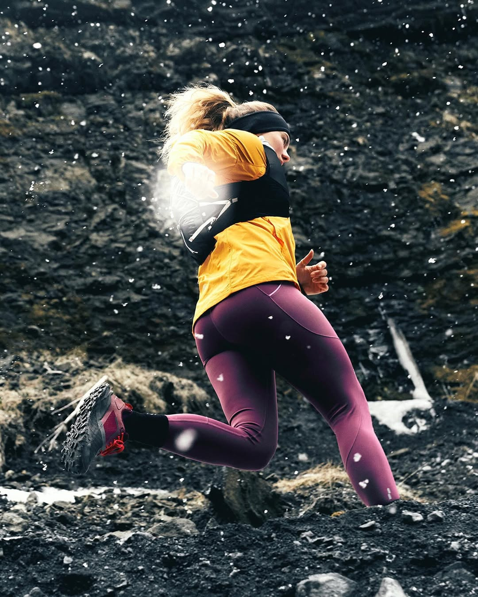 athlete running on a rocky terrain in activewear