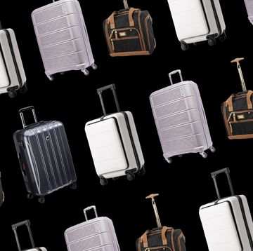 a large group of luggage bags are lined up on the floor