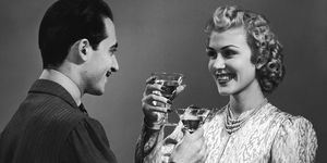a retro image of a couple toasting cocktail glasses