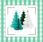 a tabletop faux christmas tree with ornaments and honey comb christmas trees with green gingham border