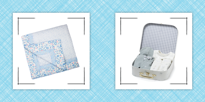 baby quilt floral pattern and suitcase of baby clothes