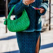paris, france   march 08 a guest is seen wearing green miu miu bag outside miu miu during paris fashion week   womenswear fw 2022 2023 on march 08, 2022 in paris, france photo by christian vieriggetty images
