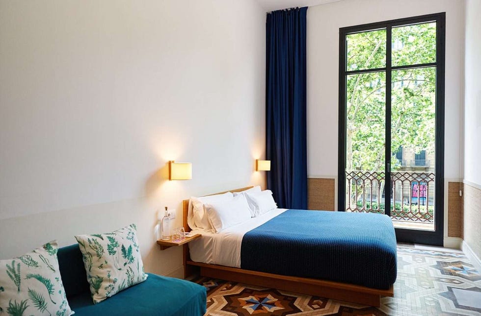a bedroom with a double bed and large window