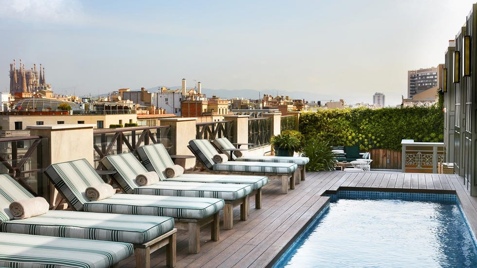 a pool with lounge chairs around it at cotton house
