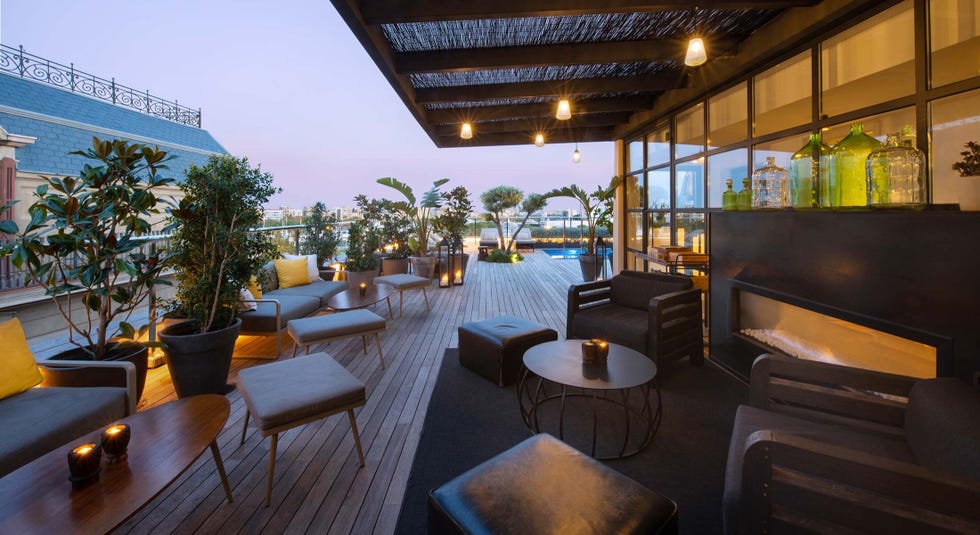 roof terrace with seating area and a pool at serras hotel