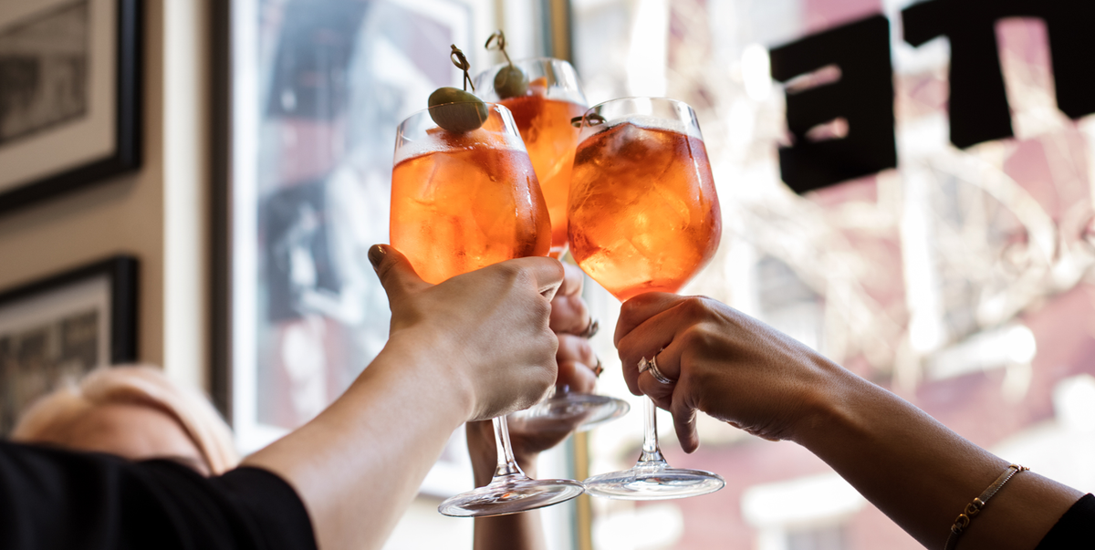 three women clinking cocktails for a cheers at dante in nyc