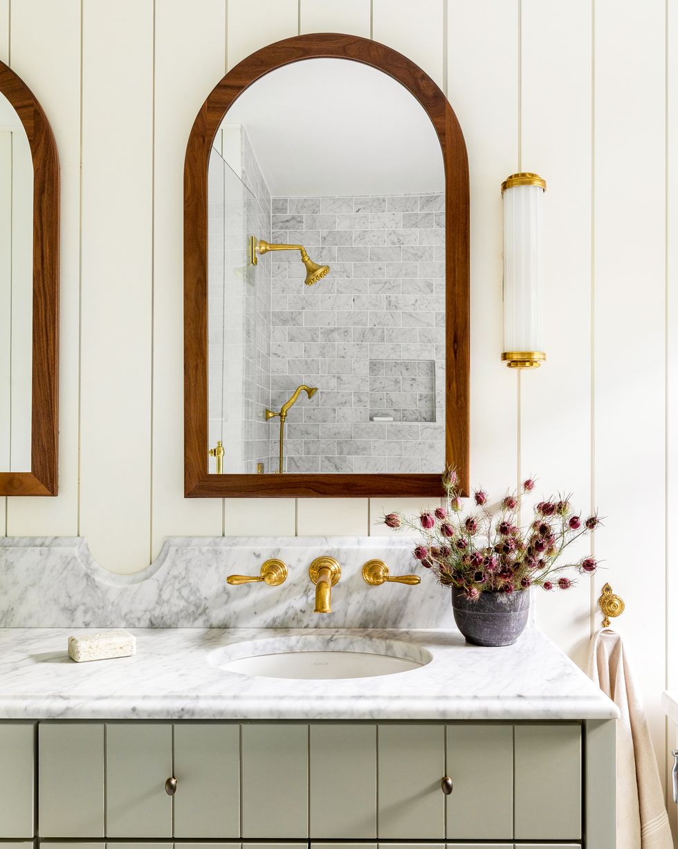 https://hips.hearstapps.com/hmg-prod/images/best-bathroom-lighting-heidi-caillier-design-seattle-interior-designer-arched-medicine-cabinets-green-vanity-vintage-british-eclectic-n28-tudor-master-bathroom-wall-mounted-sink-faucets-marble-countertops-1590685554.jpg?crop=1.00xw:0.926xh;0,0.0274xh&resize=980:*