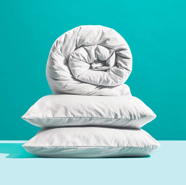 rolled up comforter on top two pillows