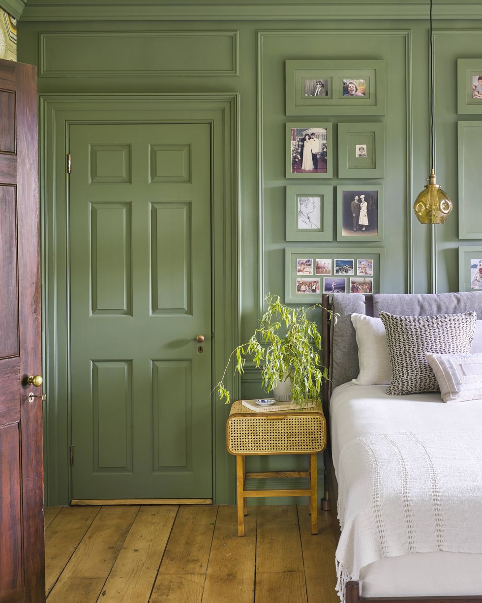 glossy green paint color for bedroom with matching wall, door, trim, gallery wall photo frames