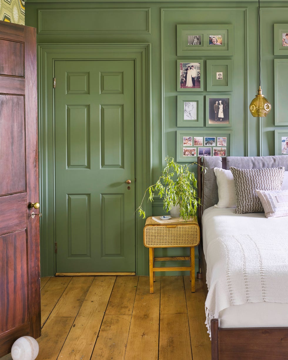 glossy green paint color for bedroom with matching wall, door, trim, gallery wall photo frames