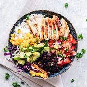 The best breastfeeding diet includes foods such as vegetables, fruits, and lean proteins like those that are featured in this grilled chicken burrito bowl