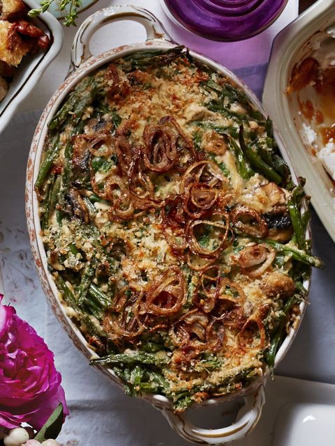 green bean casserole with fried shallots in an oval baking dish