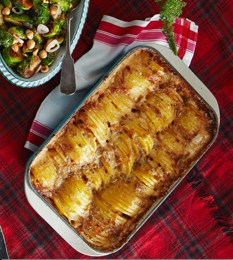 hassleback potato gratin baked in a rectangle baking pan on a red plaid tablecloth