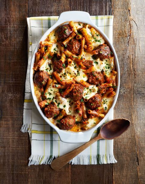 meatball spinach baked ziti in a white oval casserole dish