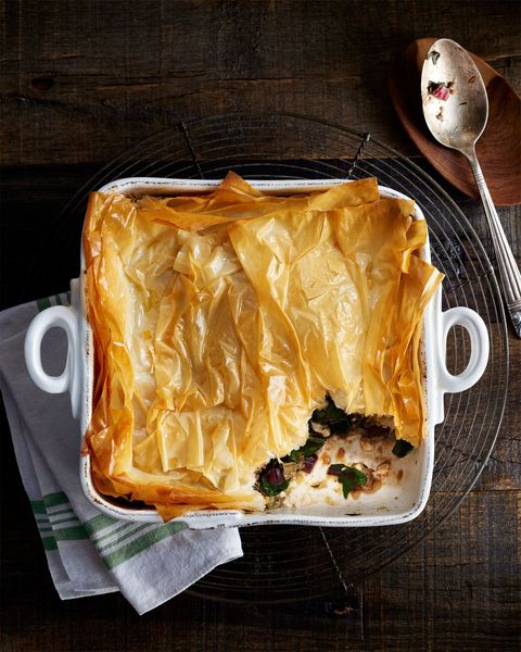 swiss chard and lamb bake topped with phyllo dough in a white square baking dish