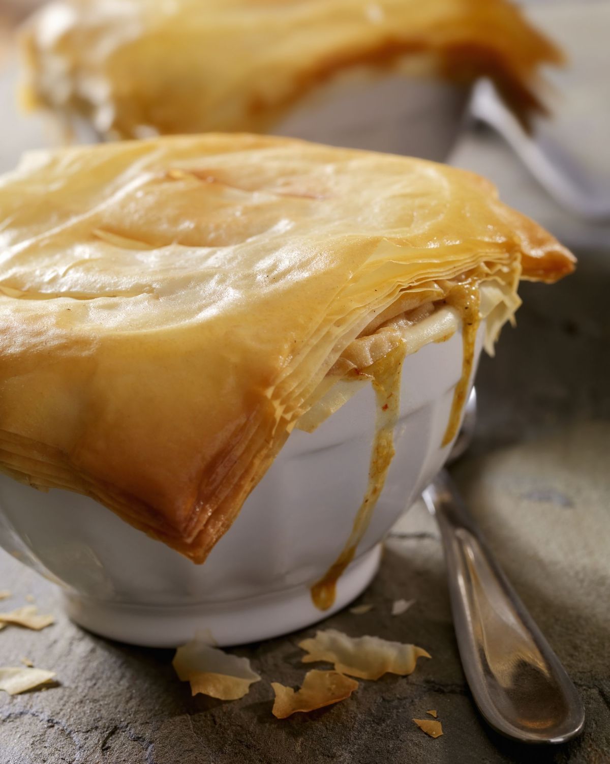 turkey pot pie with phyllo crust in individual bowls with spoons