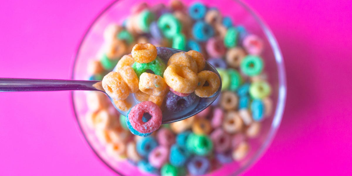 fruity cereal on a spoon above a bowl