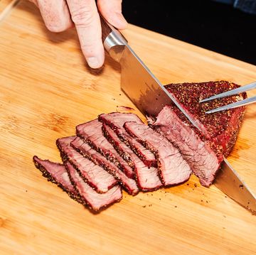 a person cutting meat with a knife