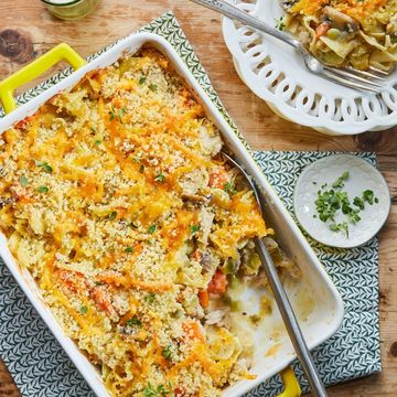 chicken noodle casserole in a big yellow dish on a wood table
