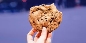 hand holding up chocolate chip cookie