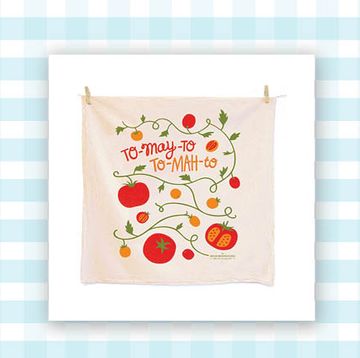 a dish towel with tomatoes on it and a photo printer