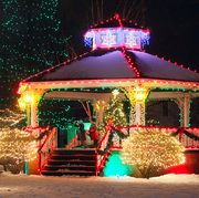 white gazebo dressed in green and red holiday lights