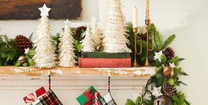 plaid christmas stockings hung on a fireplace mantel