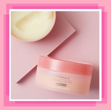 two pink pots of cleanser, one on its side and another open and facing up