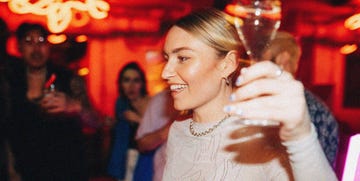 woman holding a drink in a club