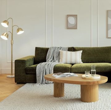 a couch with pillows and a coffee table