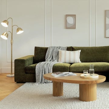 a couch with pillows and a coffee table